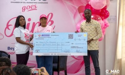 Ms Gozo (middle) receiving a cheque from the CEO of COMEC