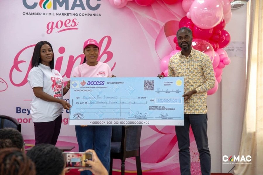 Ms Gozo (middle) receiving a cheque from the CEO of COMEC
